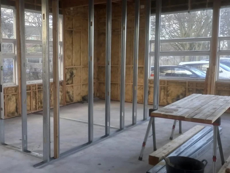Inside a wooden structure with no windows.