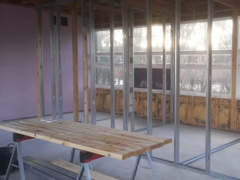 A wooden table inside a temporary building.