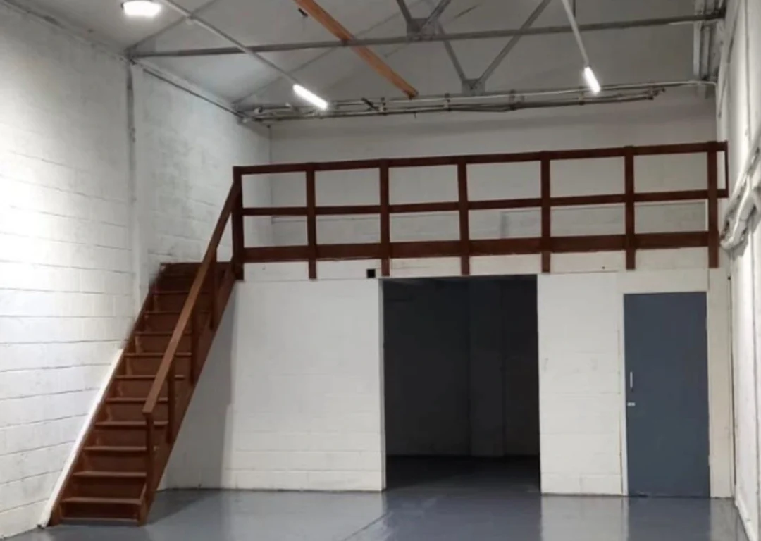 A clean, modern warehouse with grey floors and white walls.