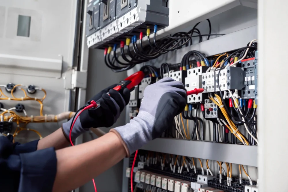 An engineer checks the electricity switchboard of a vacant property.