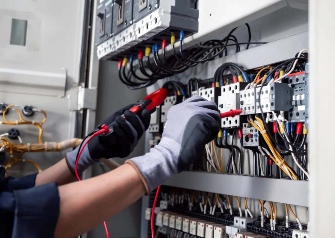 An engineer checks the electricity switchboard of a vacant property.